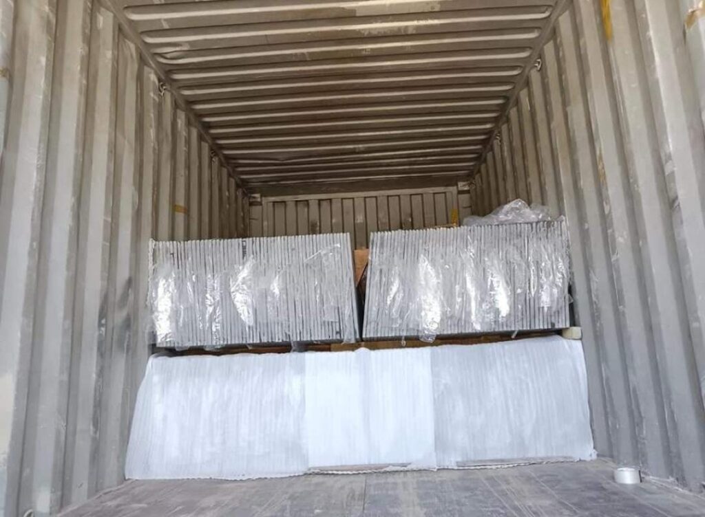 a container with a stack of Stone slabs